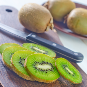 kiwi verde fresco en rodajas sobre tabla de madera