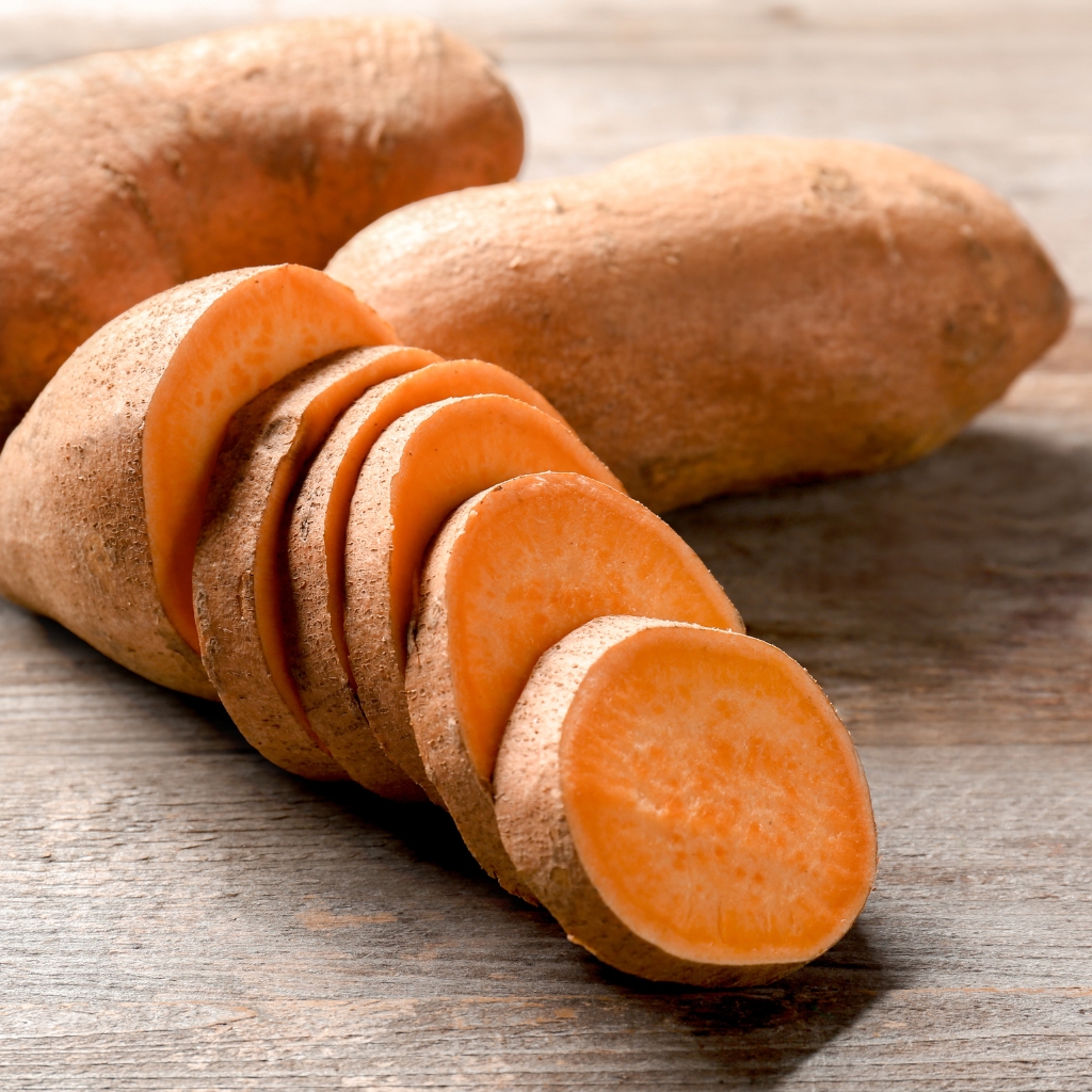 Batata o boniato fresco cortado en rodajas, con interior naranja y textura firme