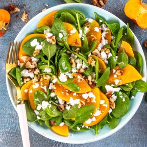 Ensalada de espinacas frescas con kaki persimon, nueces y queso