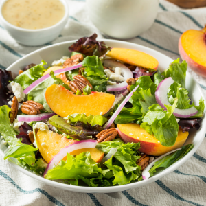 Ensalada fresca con melocotón Escola, brotes verdes y frutos secos