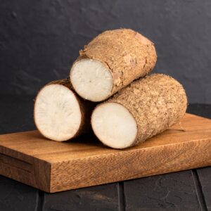 Yuca fresca 1 unidad con corte natural sobre tabla de madera